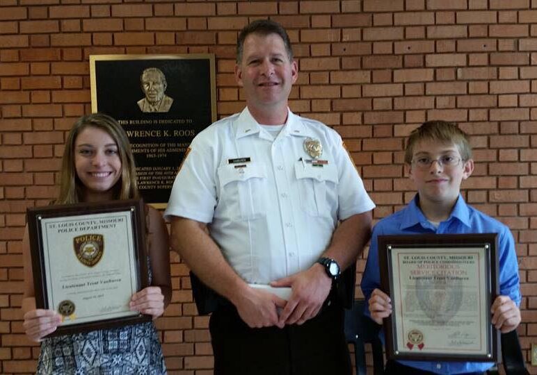 Officer with two award recipients