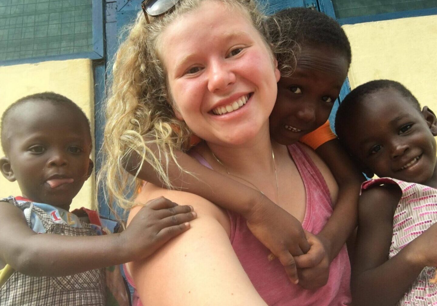 Smiling group selfie with three children