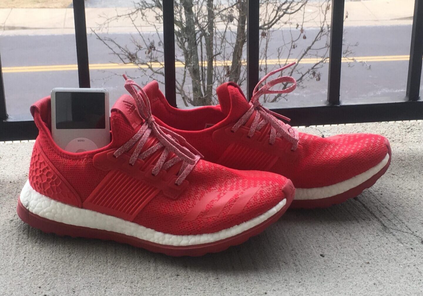 Bright red sneakers on concrete surface