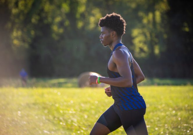 Athlete jogging outdoors in sunlight
