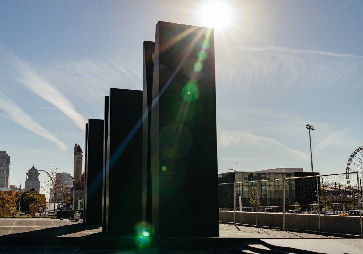 Modern sculpture with city skyline