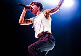 Singer performing energetically on stage