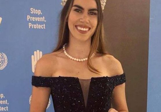 Pageant winner posing with prize