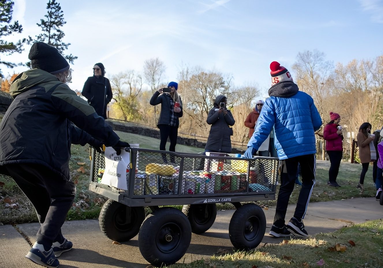 Volunteers transporting food in park setting