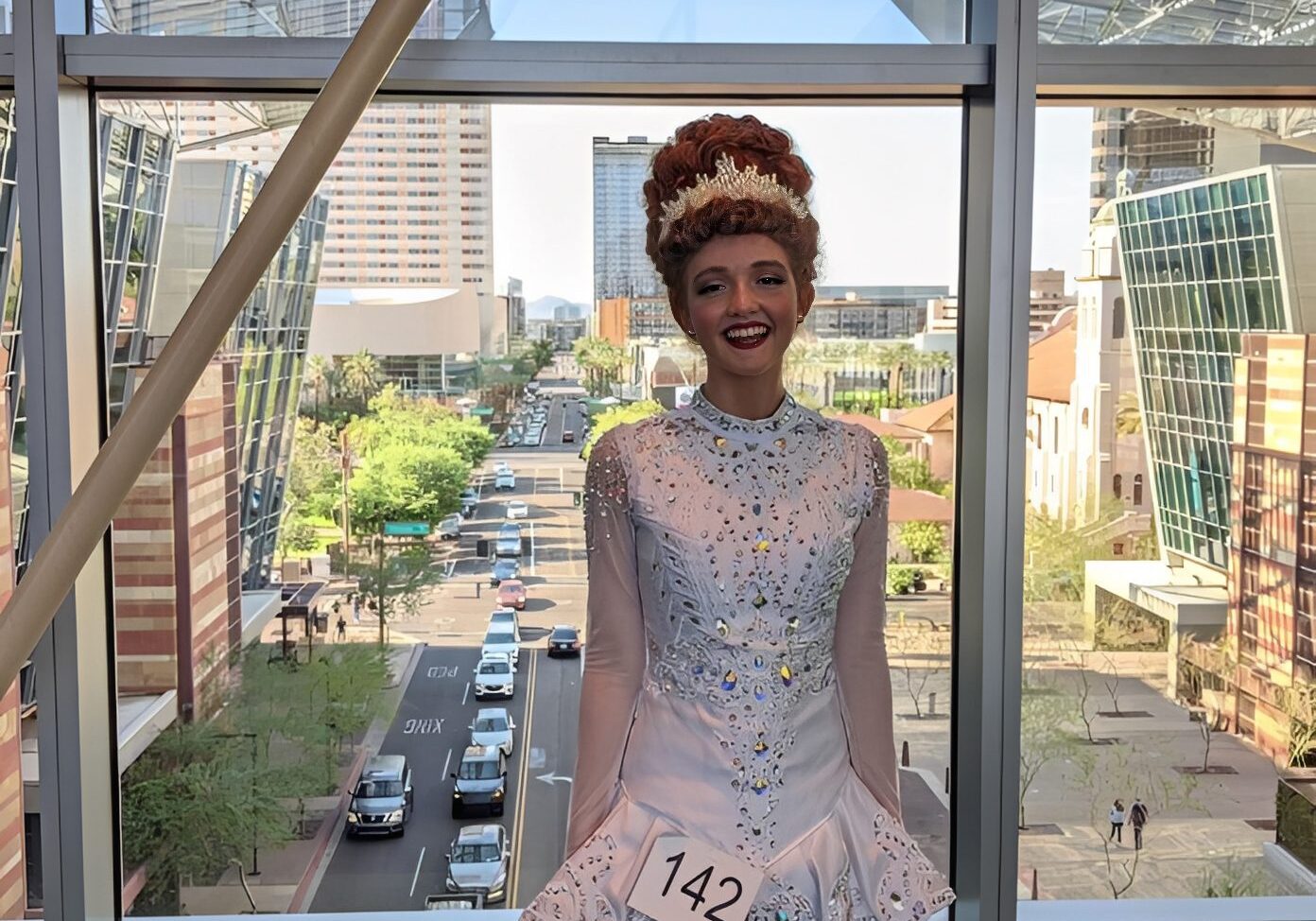 Woman in competition attire, city backdrop