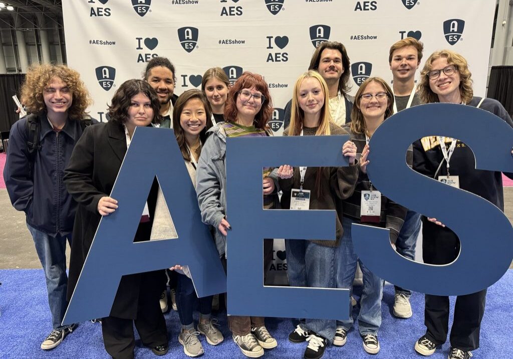Friends posing with AES sign