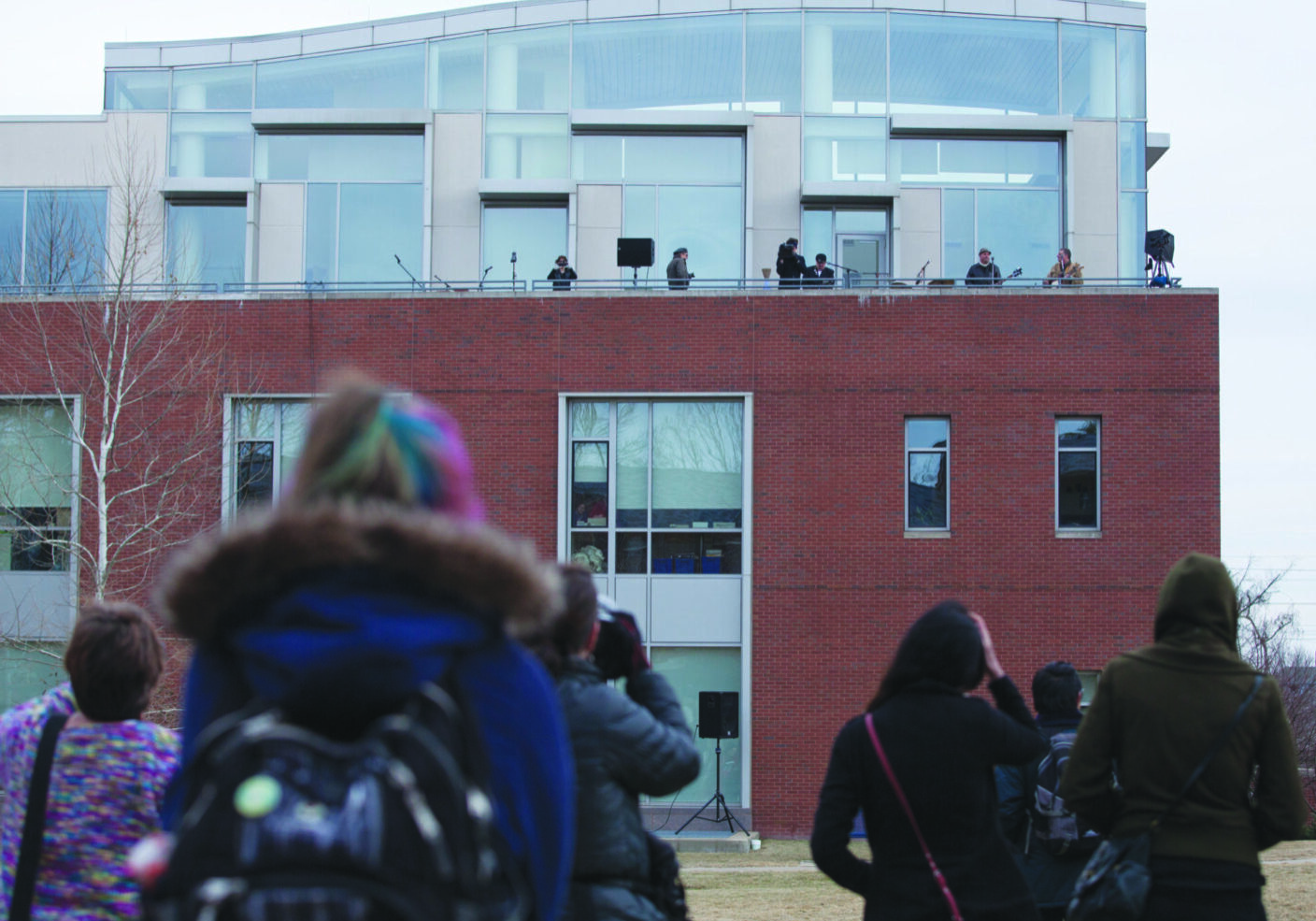 People watching performance on building rooftop
