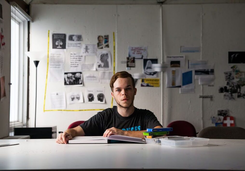 Person studying at a cluttered desk