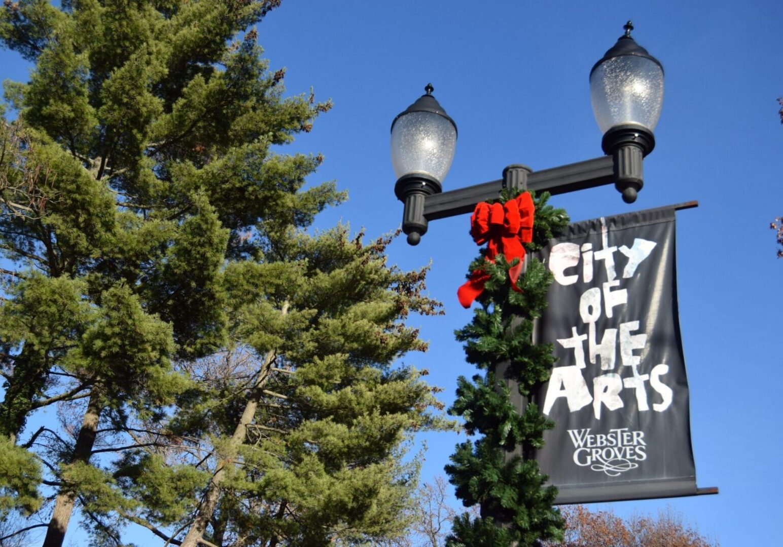 Festive street lamp with greenery and bow