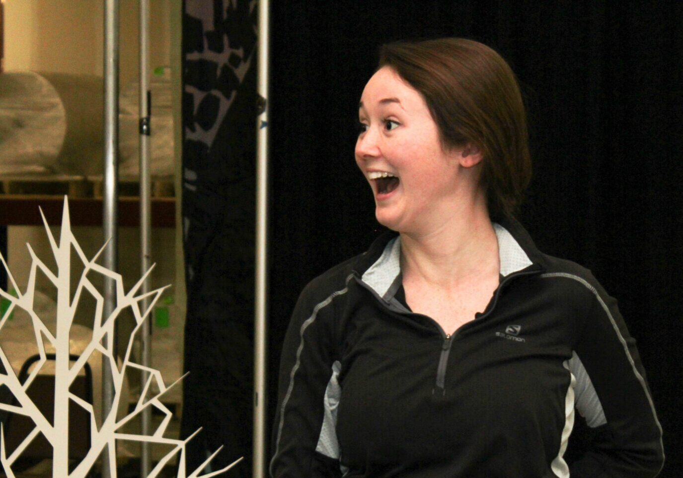 Woman surprised near decorative tree sculpture