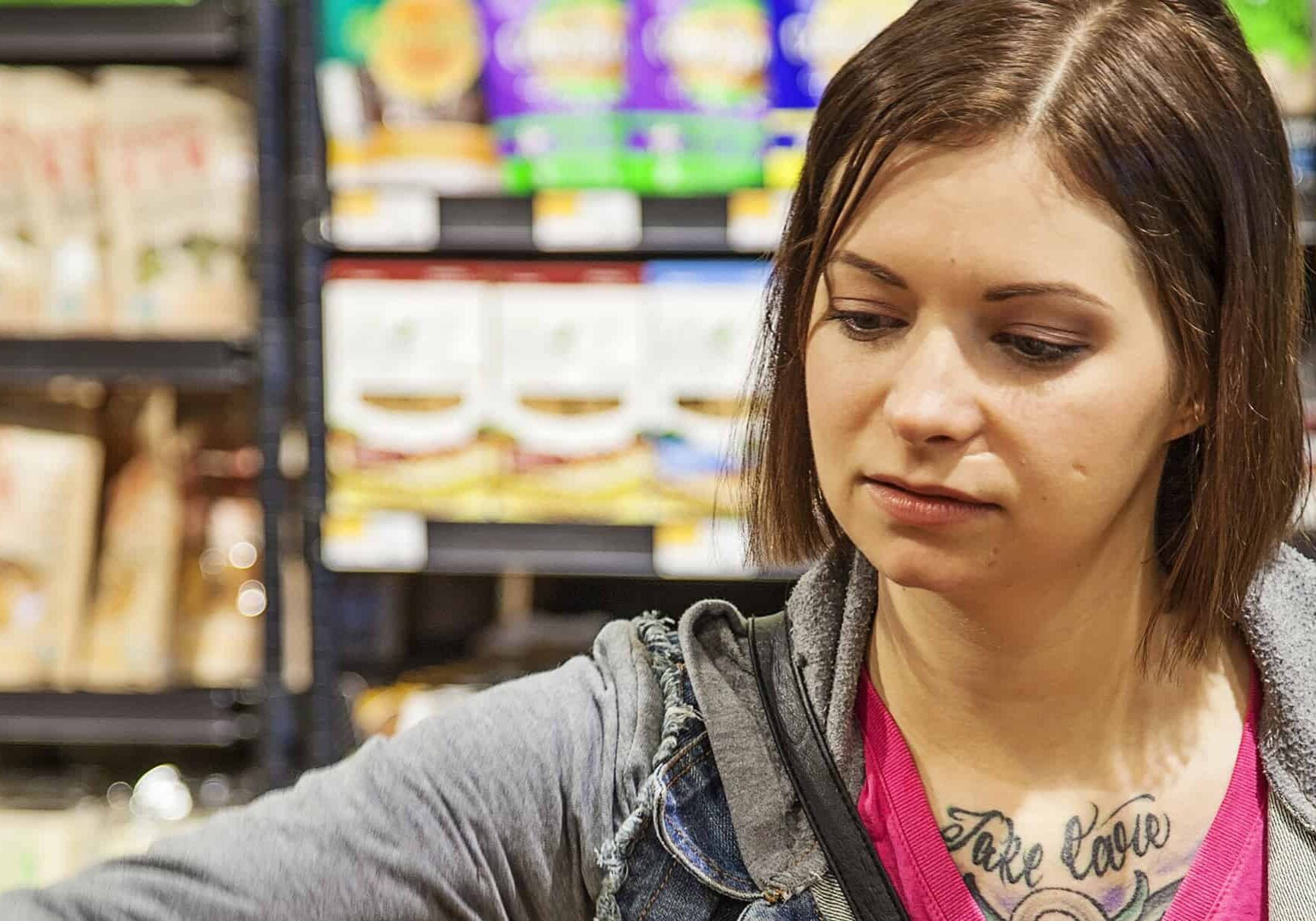 Shopper browsing food products on shelf