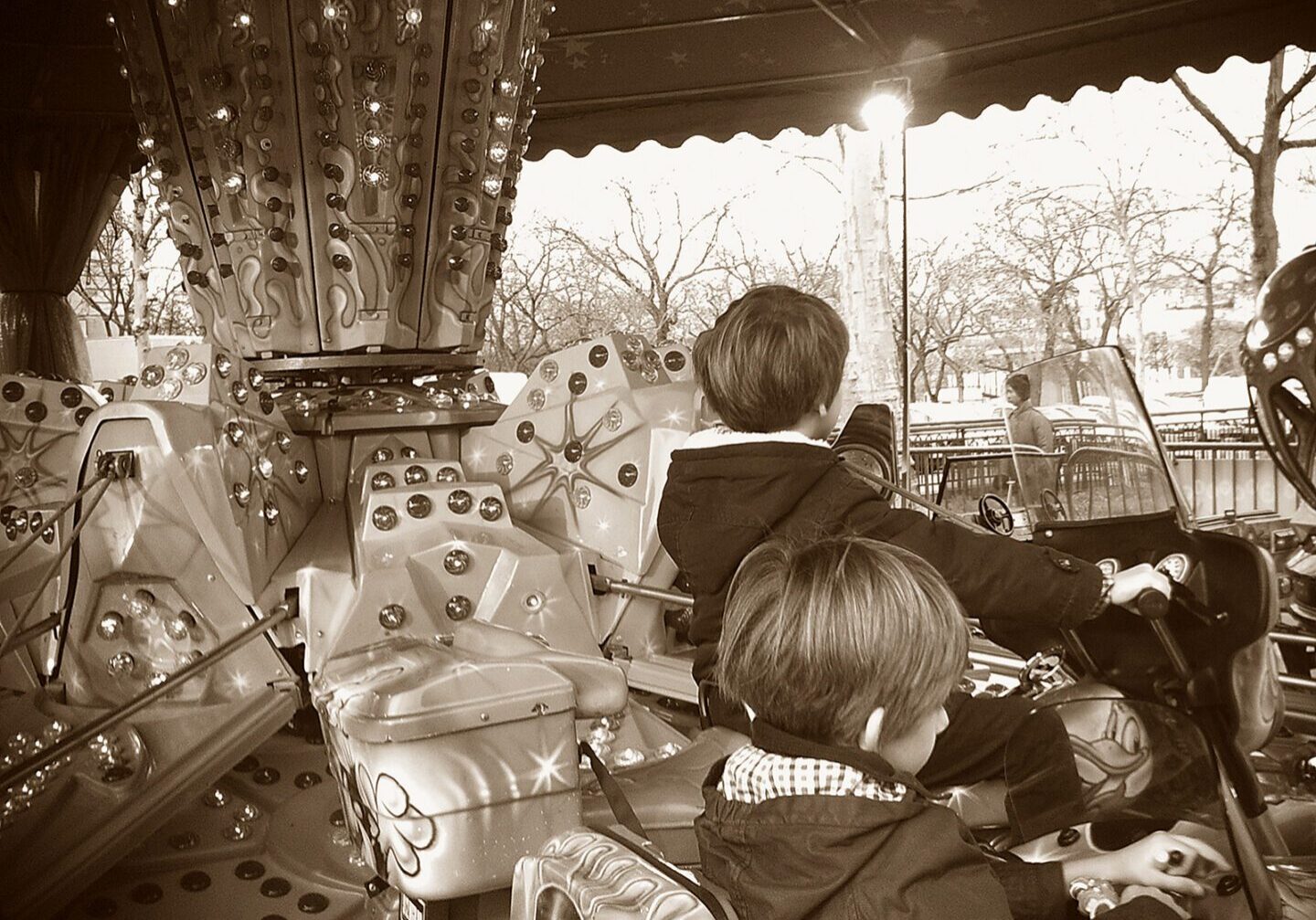 Two boys on a carousel ride
