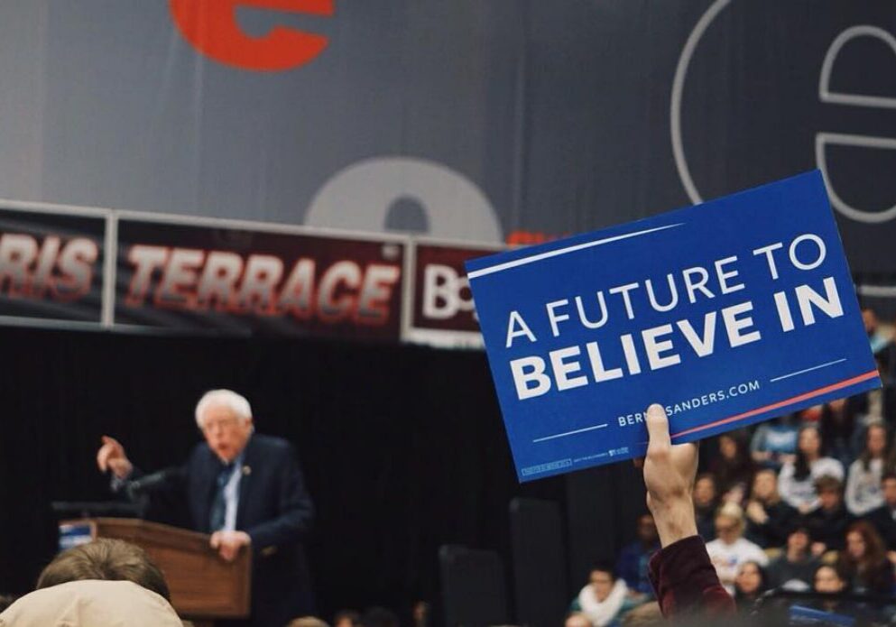 Supporter holding motivational sign