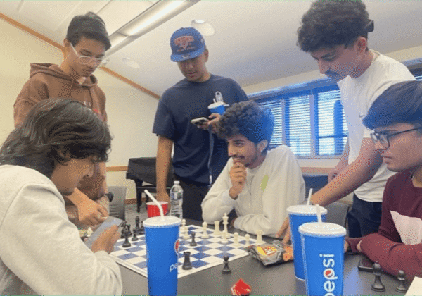 Group of friends playing chess indoors