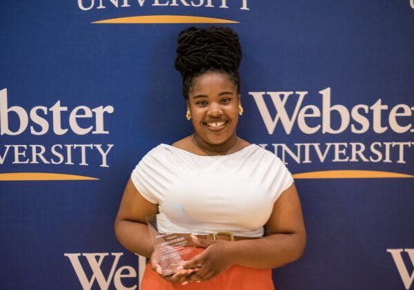 Smiling award recipient at Webster University event