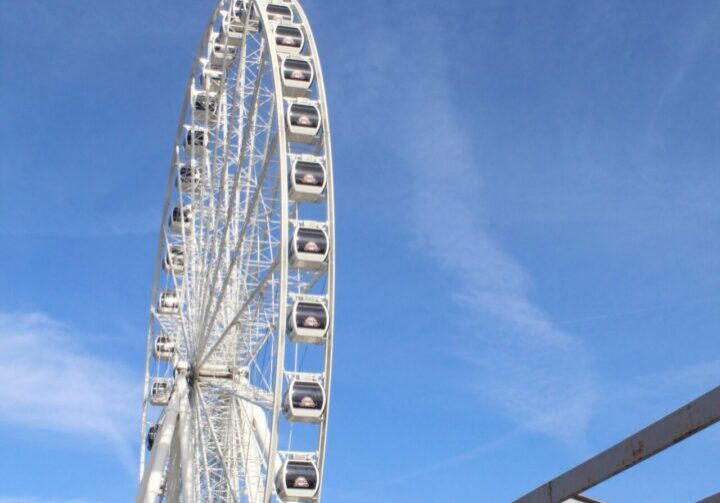 Large Ferris wheel against blue background