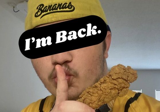 Man in yellow hat with chicken