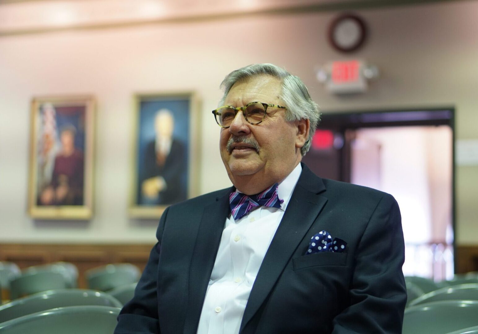 Man in suit with bowtie sitting
