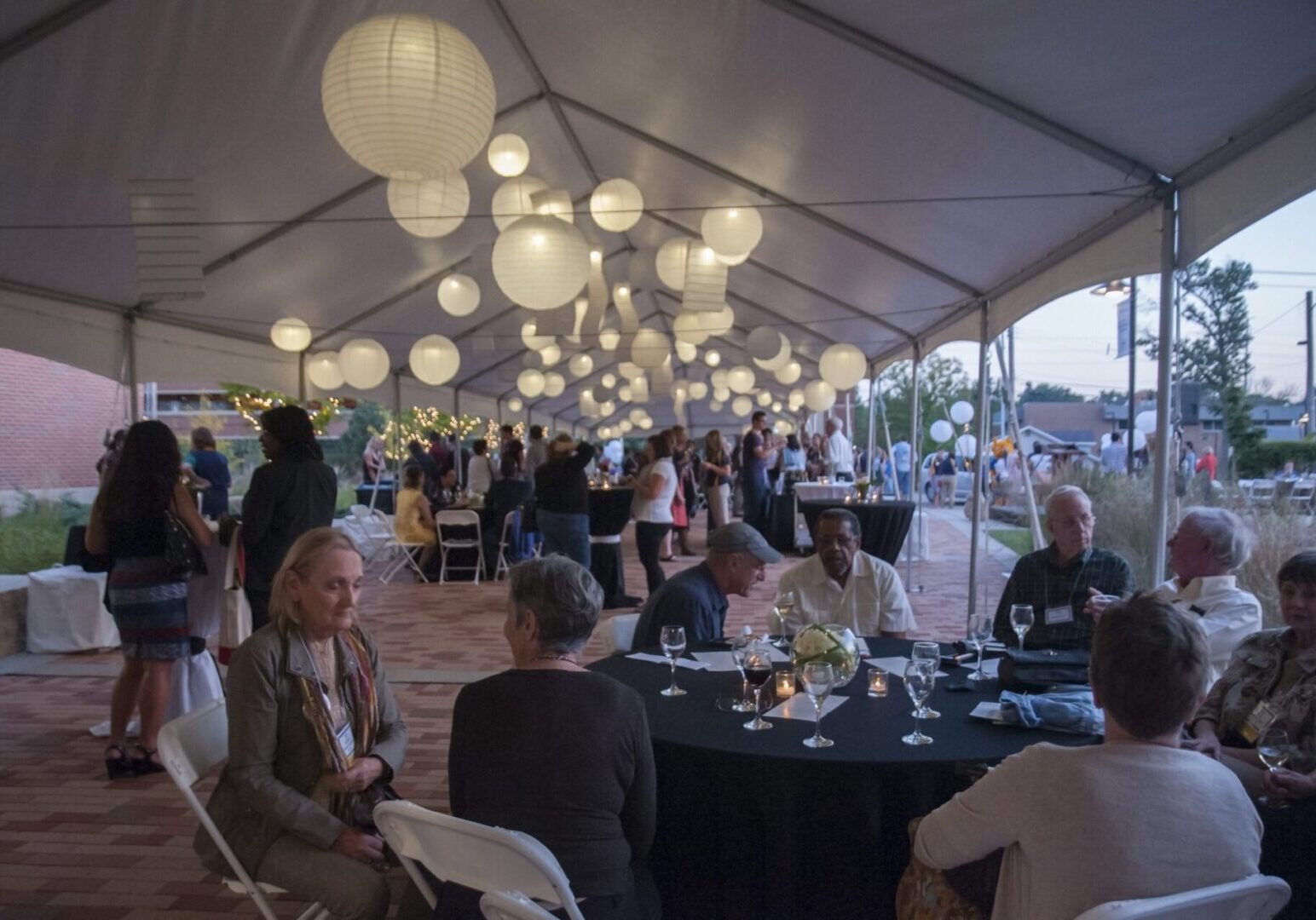 Outdoor evening event under a tent