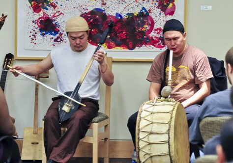 Cultural music performance with colorful backdrop