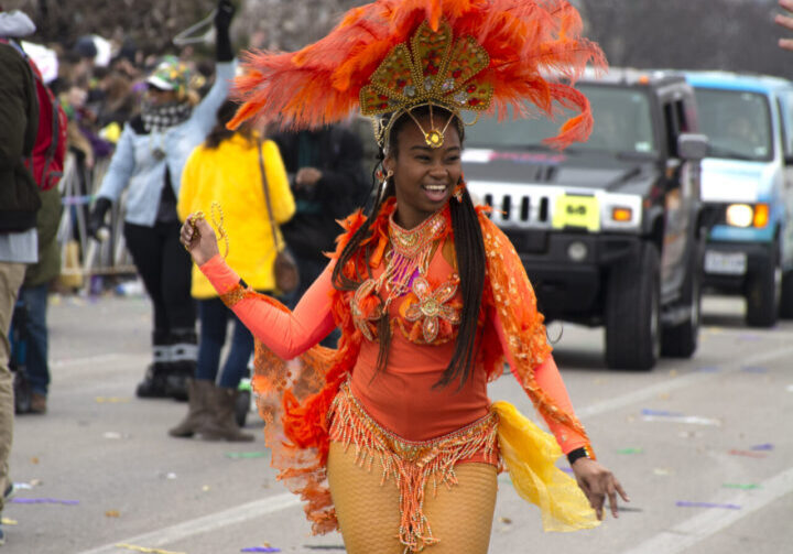 Carnival dancer in vibrant orange costume