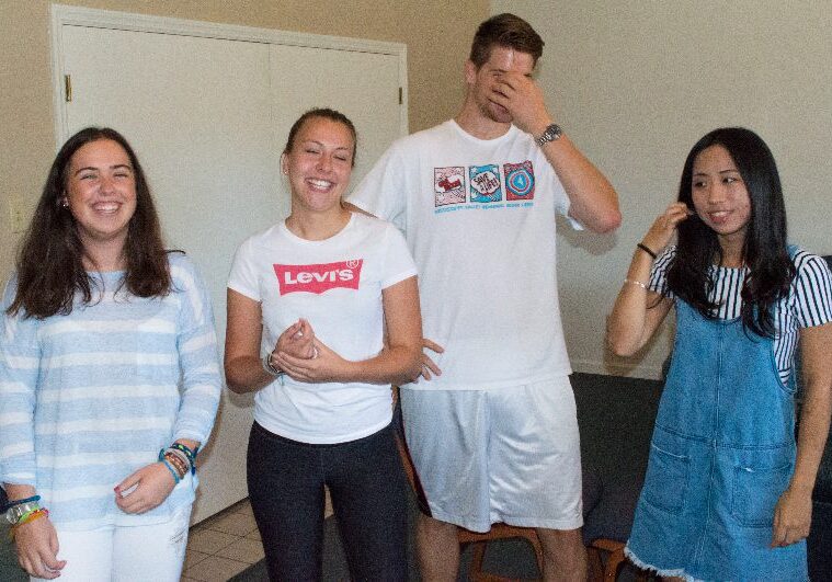 Four friends smiling and standing