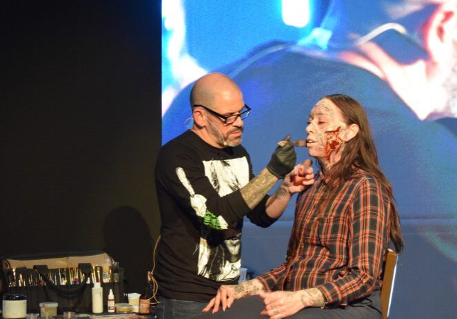 Artist creating realistic wound effects on model
