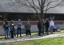 Group waiting on sidewalk