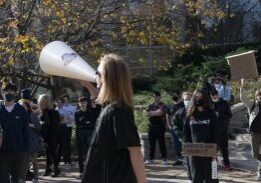 Protester speaking through megaphone at outdoor rally