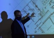 Person pointing at building plans