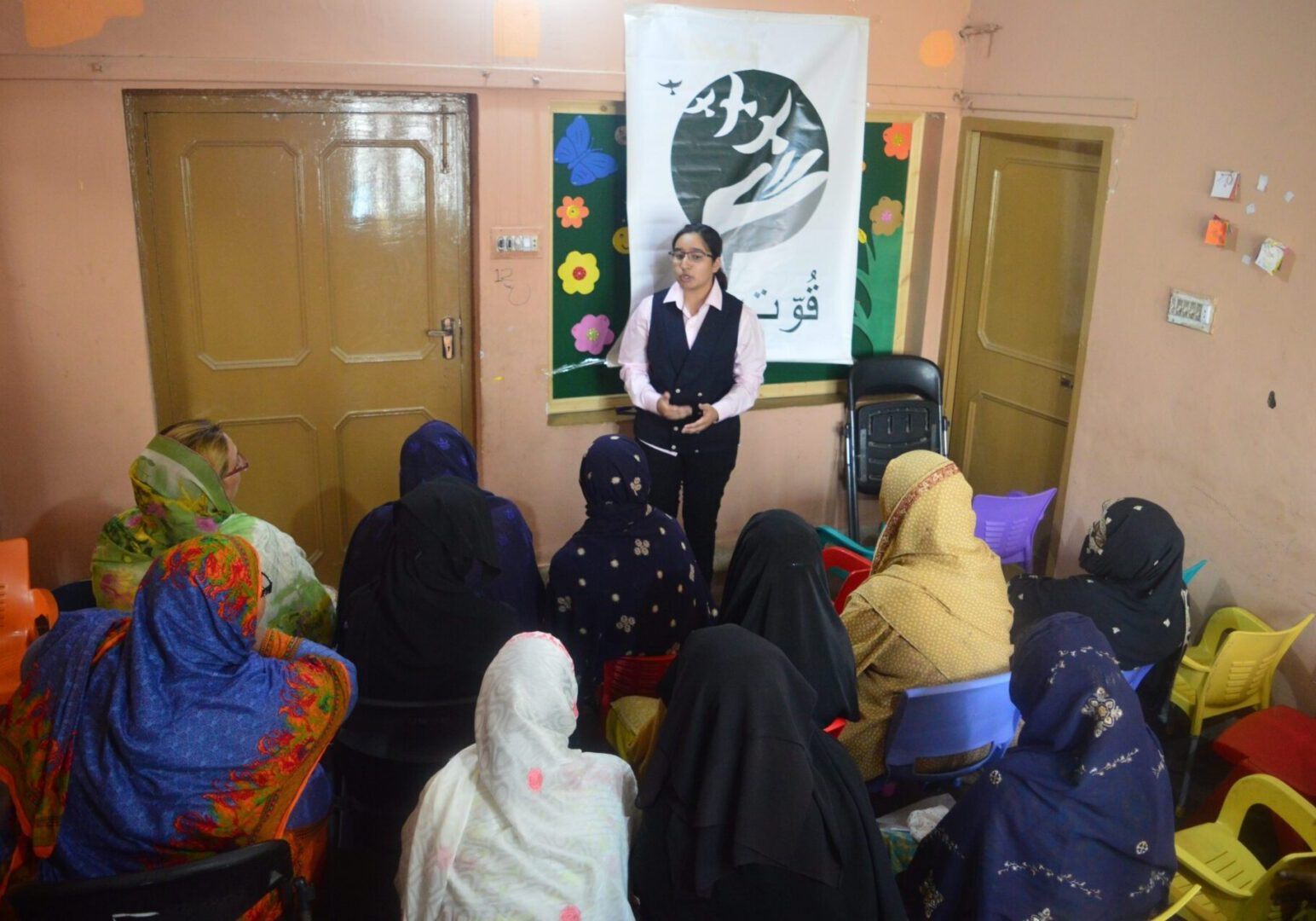 Instructor speaking to seated women