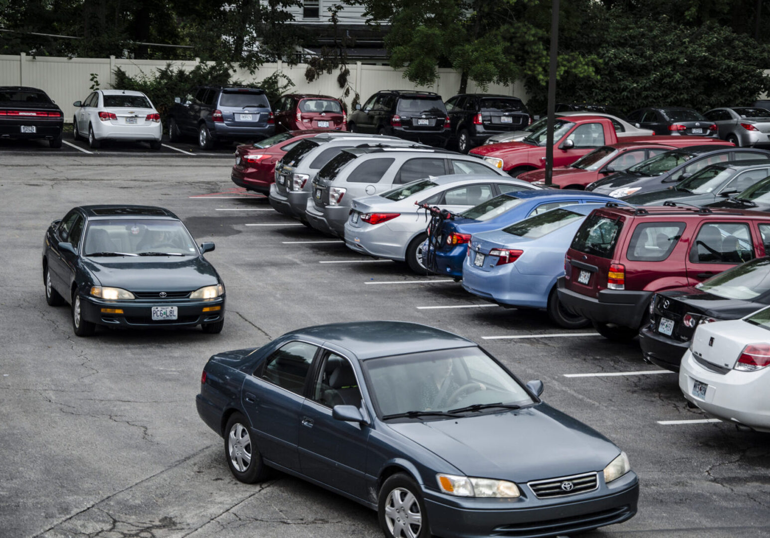 Multiple cars in outdoor parking area.