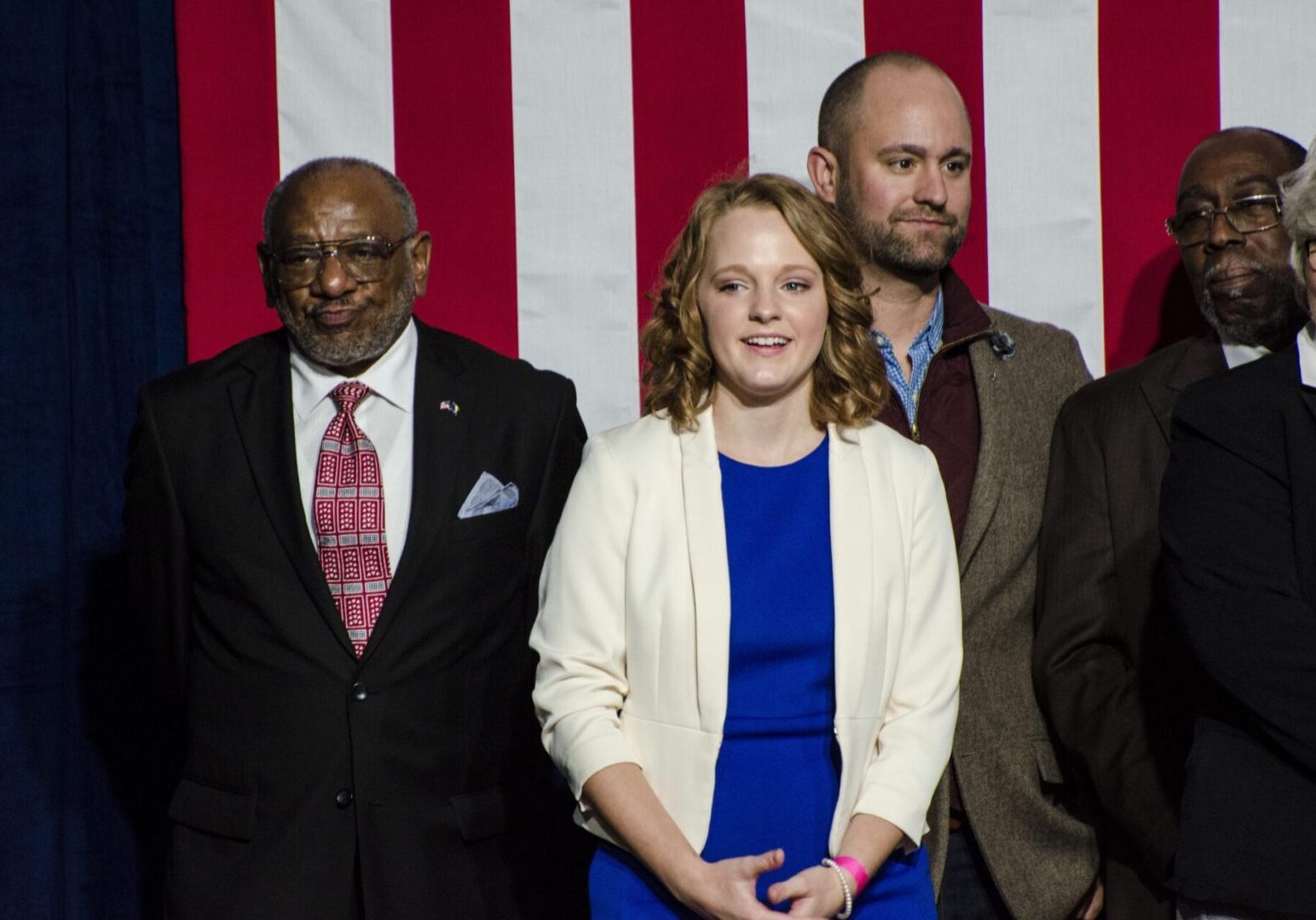 Group of people in front of flag