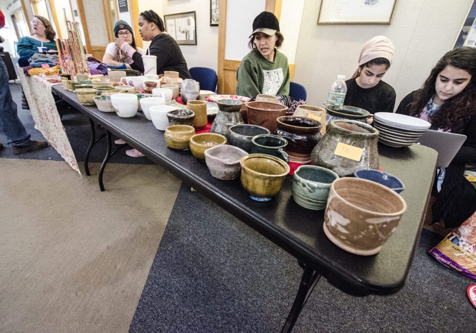 Assorted handmade pottery on black table