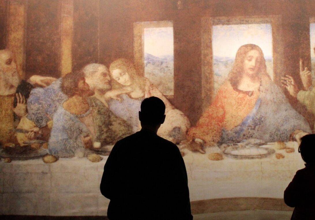 People viewing "The Last Supper" painting