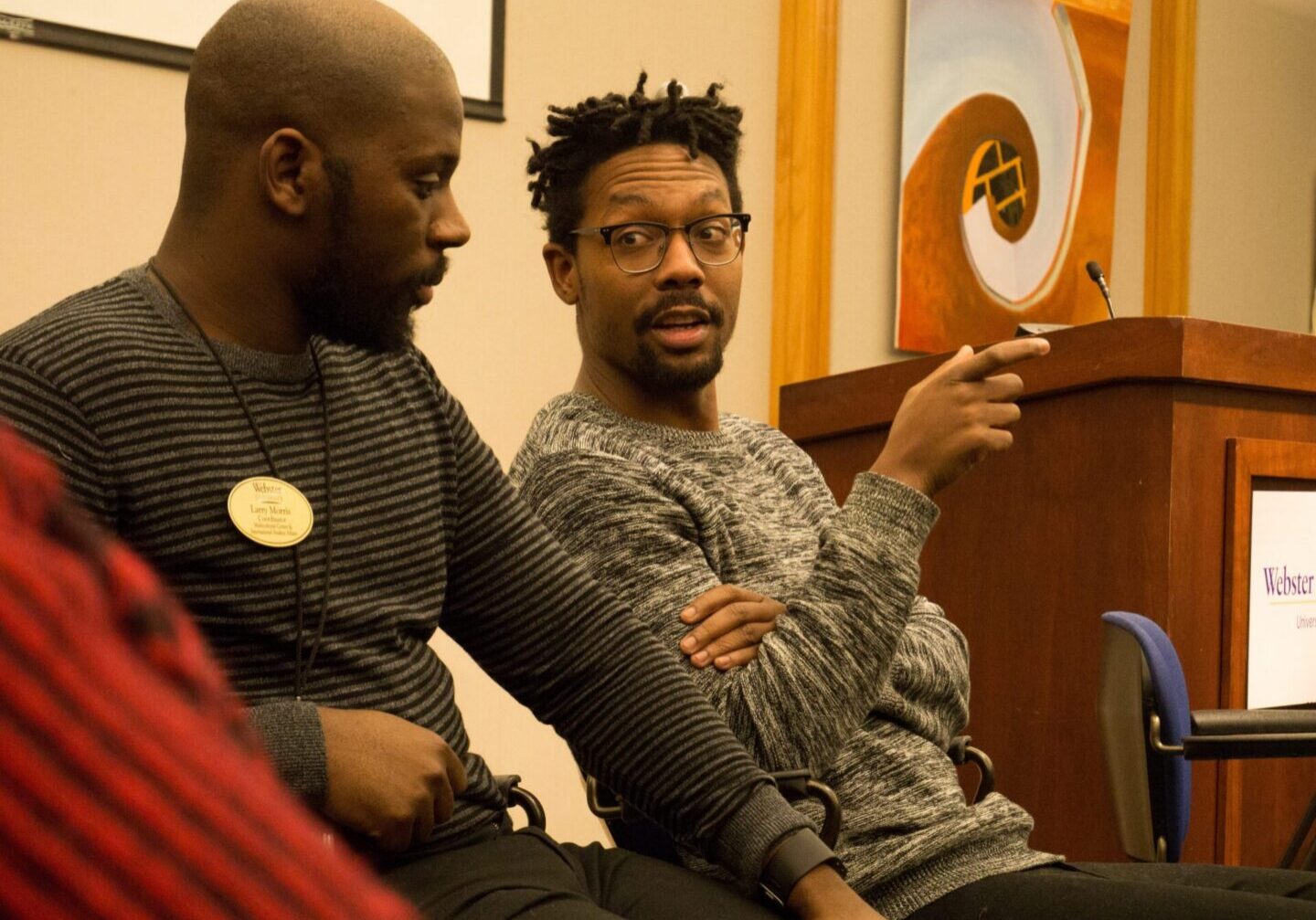 Discussion between two men indoors