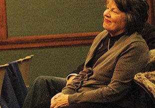 Relaxed woman in casual attire indoors