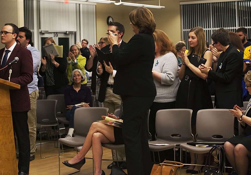 People clapping in a meeting room