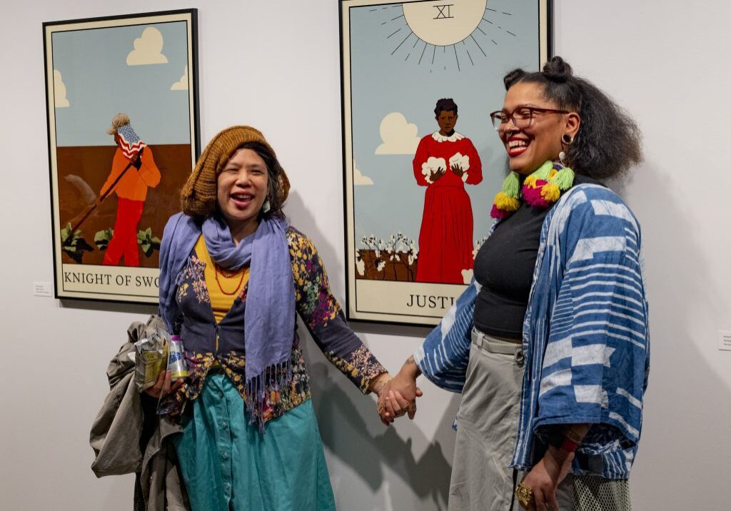 Two women smiling in art gallery