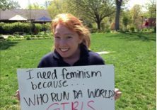 Feminism advocacy with handwritten sign in park