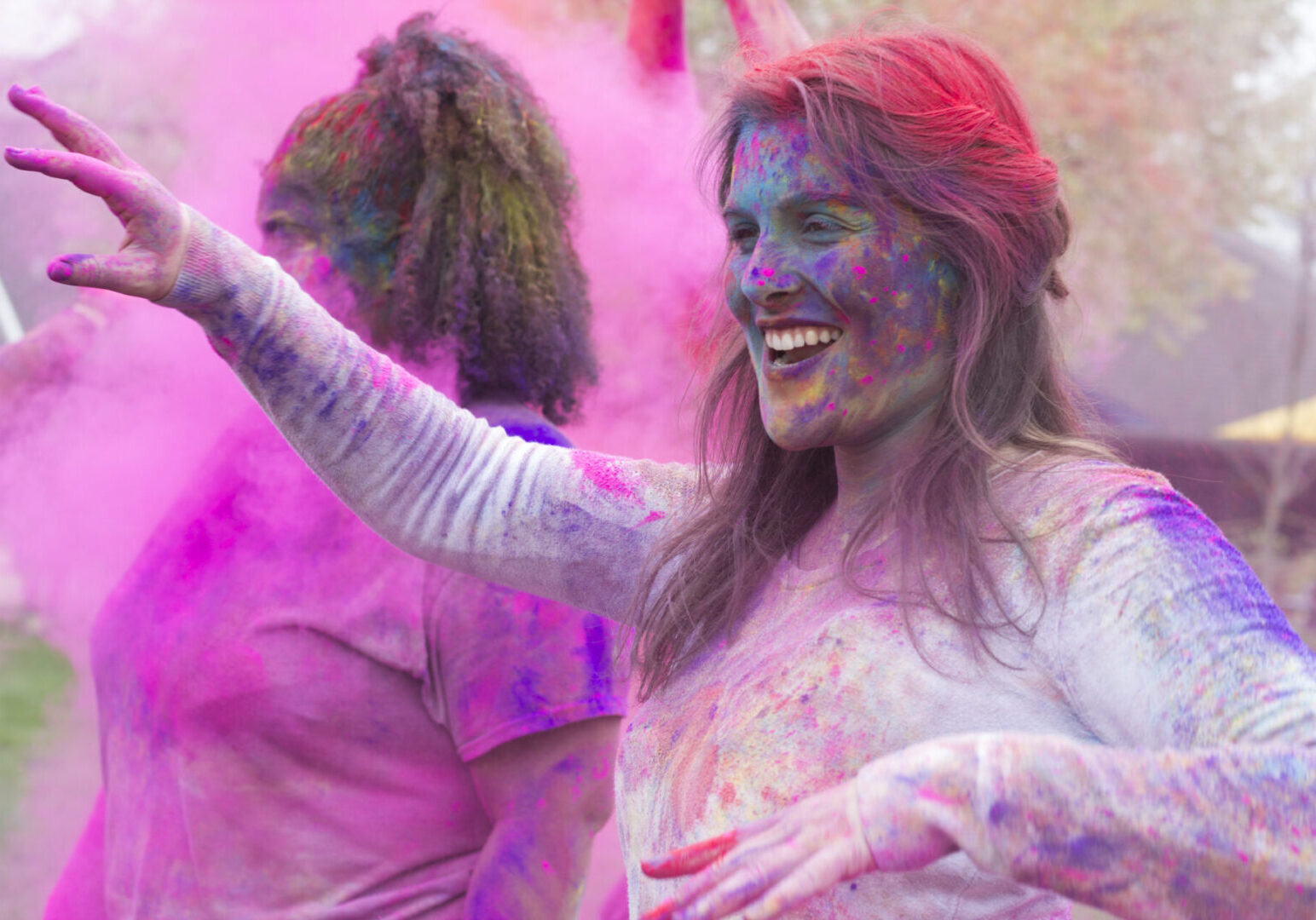 Women celebrating with colorful powder
