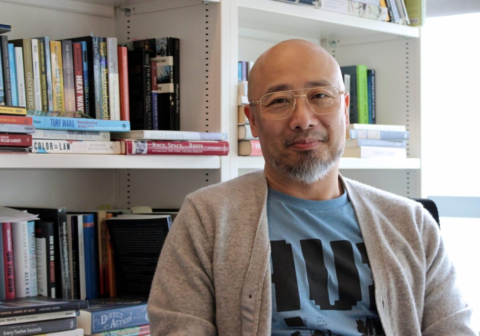 Man sitting in front of bookshelf