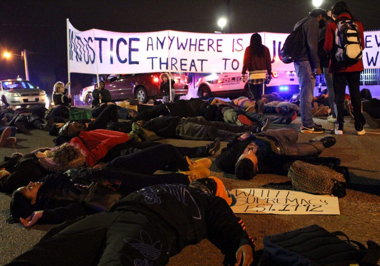 Protestors lying on street at night