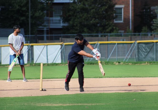 Cricket player batting on field