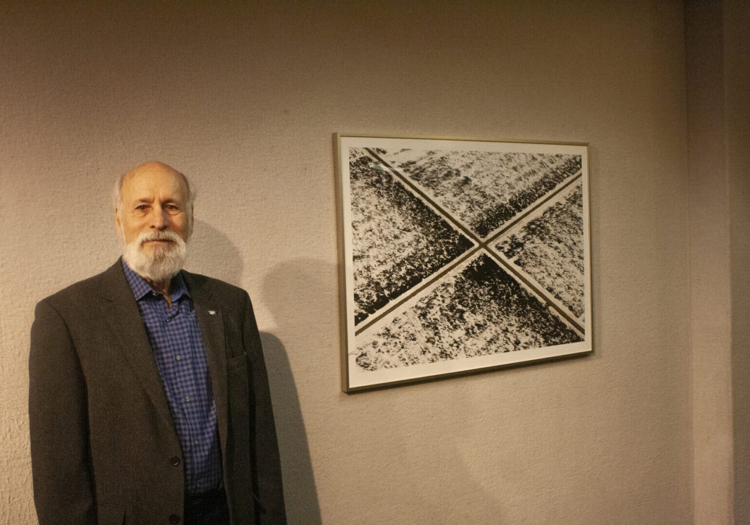 Man standing beside abstract artwork