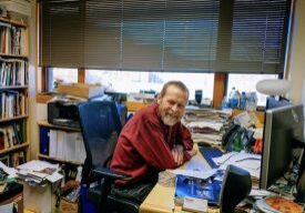 Individual smiling in a busy work environment