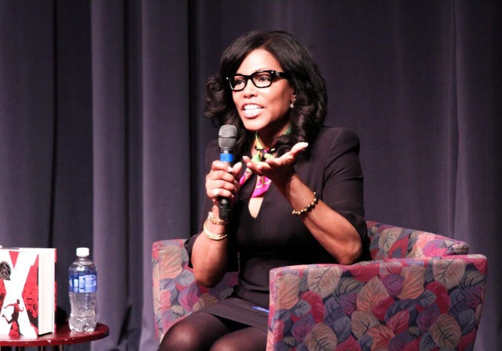 Woman in glasses talking at event