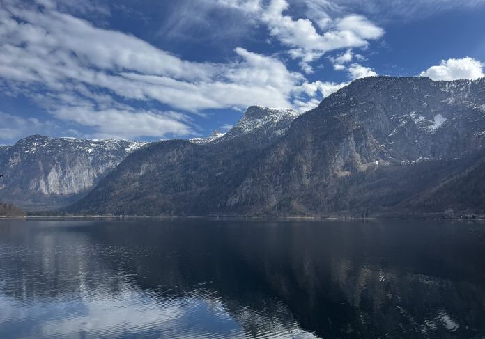 Snow-capped peaks by tranquil lake
