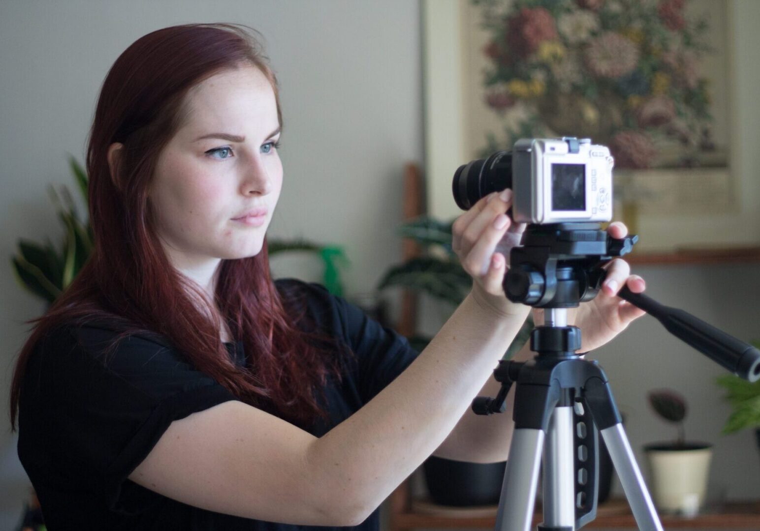 Woman setting up camera on tripod