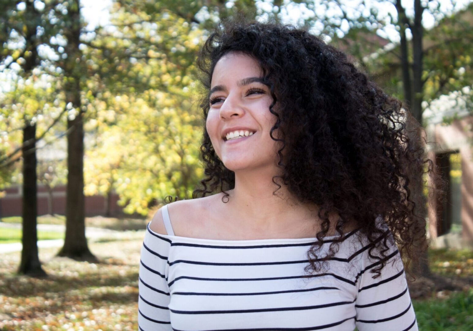 Happy woman with curly hair outside